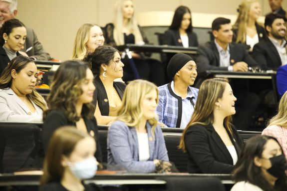 A group of students sits at an information session.
