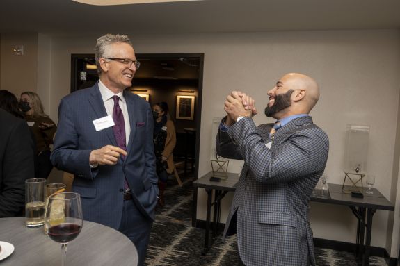 Dean Michael Hunter Schwartz talks with an alumni.