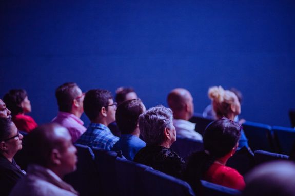 People Sitting on Chairs in an auditorium