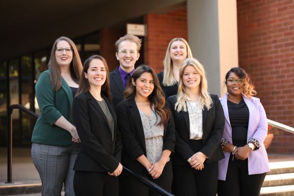 A group of seven students pose for a photo