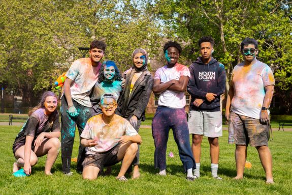 Students covered in colored powder for Holi