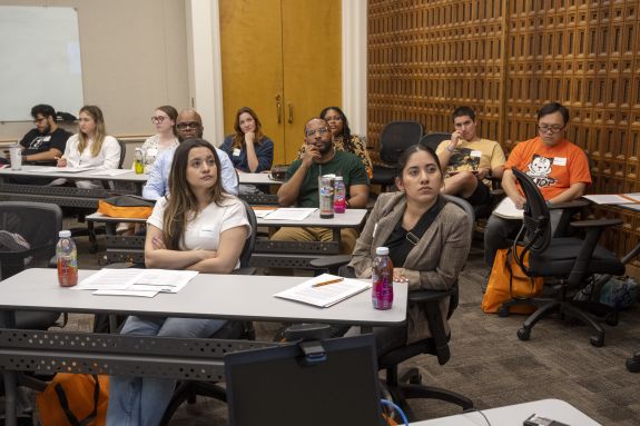 students listen in on an info session
