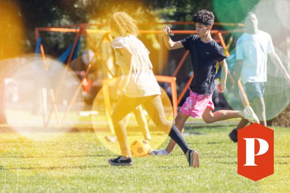 Students playing soccer on the lawn