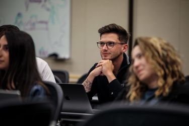 A student sits in a lecture hall.