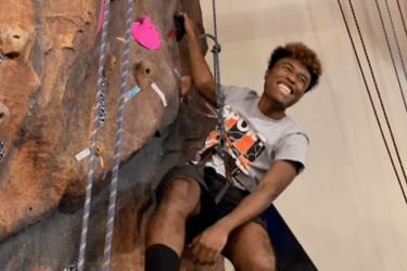 person climbing on artificial rock wall