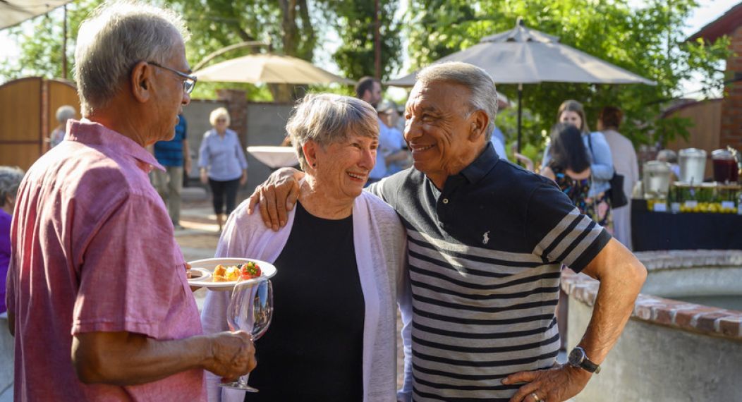 three OLLI members talk at a winery