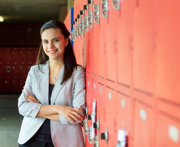 woman standing next to a row of lockers